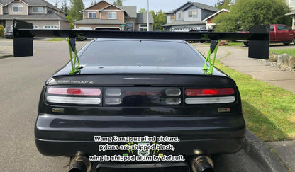 A black Nissan Fairlady Z with a large aftermarket spoiler from the 300ZX Big Wang kit '88-00 Z32 by 9livesracing is parked on a suburban street. Neon green pylons supporting the spoiler are mounted on the roof of the car for effective downforce. Text on the image reads, "Wang Gang supplied picture; pylons are shipped black, wing is shipped alum by default.