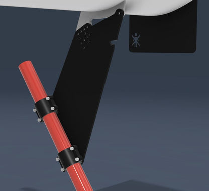 A close-up view of the Exocet v2 Big Wang Kit by 9livesracing, showcasing a black mount attached to a white surface with a red rod secured by black brackets, designed for optimal GT3 performance. The mount features several bolts and includes a small icon of a person in the upper right corner. The background is dark and plain.