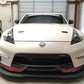A white sports car branded with Nismo is parked in a garage, proudly showcasing its Rocket Nose Coating and the prominent 370z Rocket Nose v2 Splitter ’08-20 Z34 from 9livesracing. The car features hood vents and a "SONOMOTORSPORTS" banner on the windshield, with a partially visible blue screen-printing press and other workshop equipment in the background.