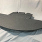 A large, curved black piece of foam lies on a light gray fabric backdrop. This 9livesracing product, identified as Mazda Miata Splitters for the 1990-05 NA/NB models, features several cutouts and is slightly elevated at the back, possibly indicating it is designed to enhance downforce as an automotive chin spoiler.