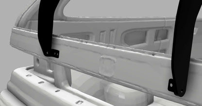 A close-up view of the 9livesracing Civic Hatch EF Wang kit (88-91) reveals a white metal structure, accented with black brackets at various points. The design includes a curved bar and rectangular cutouts, showcasing visible welds and bolts. This component is specifically engineered to enhance down-force for improved vehicle performance. It is set against a gray background.
