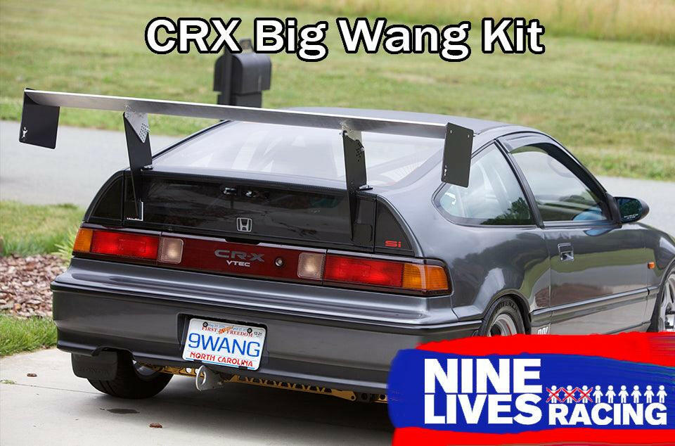 A grey Honda CRX from '83-'91 is shown from the rear, fitted with a sizable aluminum wing designed for increased down-force. The vehicle sports a North Carolina license plate with the number "9WANG." The text "CRX Big Wang Kit '83-91" is prominently displayed at the top, while a "9livesracing" logo can be seen at the bottom right.