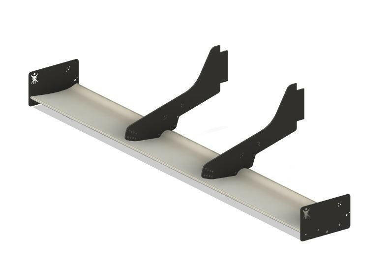 The Exocet Chrome Horn Nose Wang Kit by 9livesracing is a metal wall bracket with a long horizontal base and two vertical supports, reminiscent of aluminum wings in its sleek design. The base is perfect for mounting shelves or other items, featuring screw holes at each end. The vertical supports are angled like airfoils for added strength and stability.