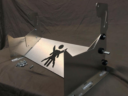 The 9livesracing Miata Sturdy Boii Splitter Mounts '90-05 NA/NB feature a custom metal bracket with a stylized figure cutout design on its front panel, set against a dark backdrop. Resembling Miata Splitter mounts, the bracket includes angled supports on both sides and comes with fasteners placed beside it, ready for assembly.