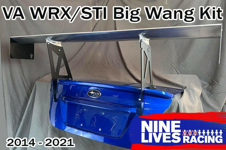 Image of a substantial aluminum rear wing kit mounted on the trunk lid of a blue Subaru WRX/STI, designed for models from 2014 to 2021. Text reads "Subaru Impreza / WRX / STI Big Wang kit 14-21 VA" and "9livesracing" accompanied by their logo in the bottom right corner, enhancing downforce for your Subaru.