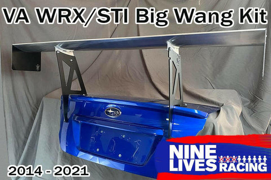 Image of a substantial aluminum rear wing kit mounted on the trunk lid of a blue Subaru WRX/STI, designed for models from 2014 to 2021. Text reads "Subaru Impreza / WRX / STI Big Wang kit 14-21 VA" and "9livesracing" accompanied by their logo in the bottom right corner, enhancing downforce for your Subaru.