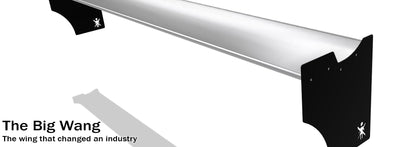 A black and white image shows a large aerodynamic wing mounted on two brackets. The product name "Integra Wang kit '94-01" is displayed in bold text on the bottom left, followed by the tagline "The wing that changed an industry." The logo of 9livesracing is featured on the brackets.