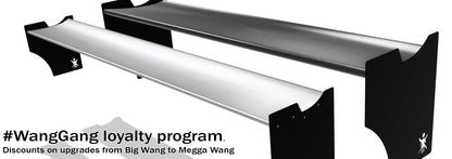 Two Ariel Atom Big Wang rear wings by 9livesracing, designed with advanced airfoils to optimize the lift-to-drag ratio, are displayed side by side against a white background. The text at the bottom reads, "#WangGang loyalty program. Discounts on upgrades from Big Wang to Megga Wang." The image promotes a discount program for upgrading car parts.