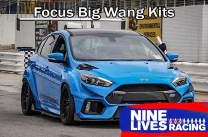 A blue Ford Focus with a large rear wing is showcased in a service area, with "Focus/RS Big Wang Kit '11-18 3rd Gen" text above and "9livesracing" branding in the bottom right corner. The car features custom modifications, including aluminum wings, a front splitter, and wide wheel arches for added down-force.
